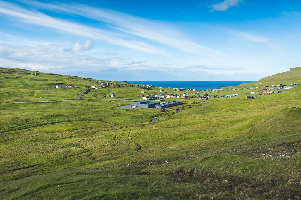 Beautiful green mountain in Skálavík, where Mølin Guesthouse in located by the sea.